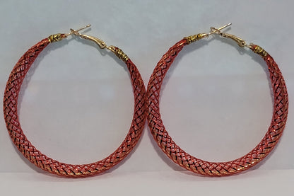 Red lace hoop earrings on a white background
