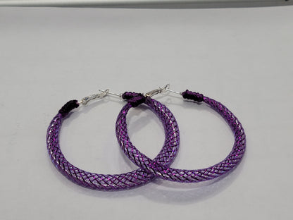 Purple braided lace hoop earrings on a gray background