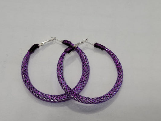 Purple braided lace hoop earrings on a gray background