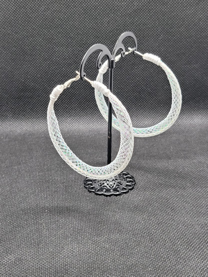 White lace and Silver hoop earrings on a gray background