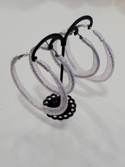 White lace silver earring with black reel on a white background